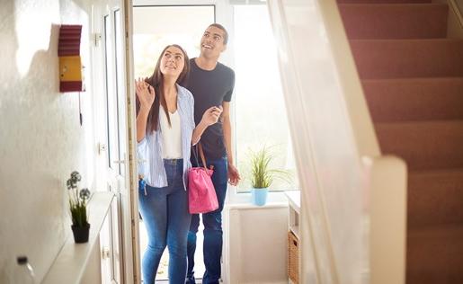 New homeowners walking into their new home